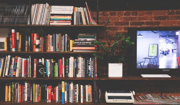 Books on shelves and a screen.